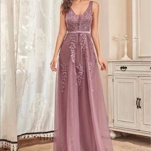 Worn once. Beautiful dress. The color is unique and really nice.